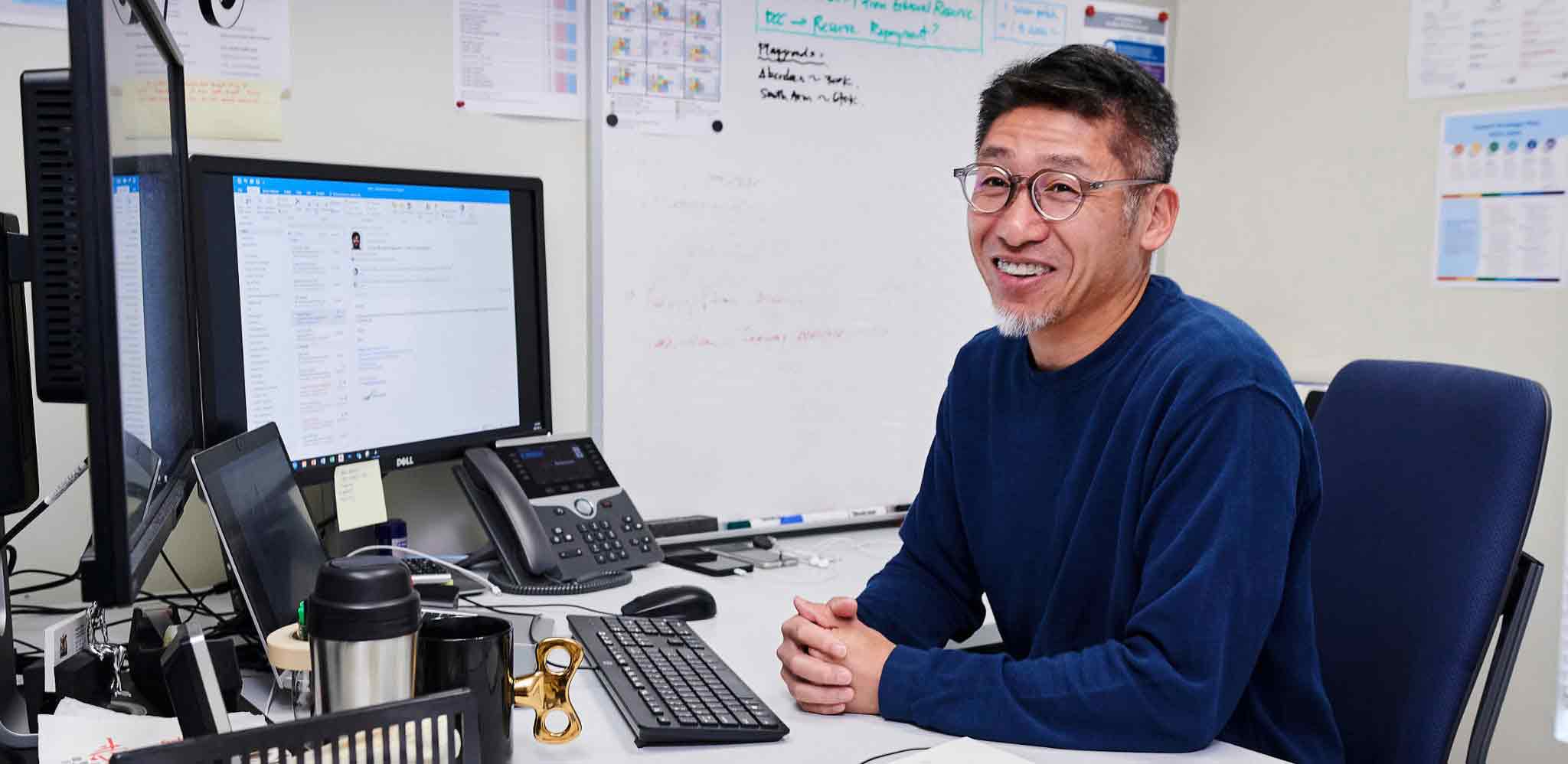 Happy employee in his desk
